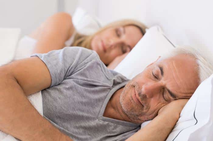 husband and wife sleeping peacefully in bed